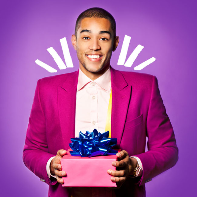 Guy holding pink present with blue bow