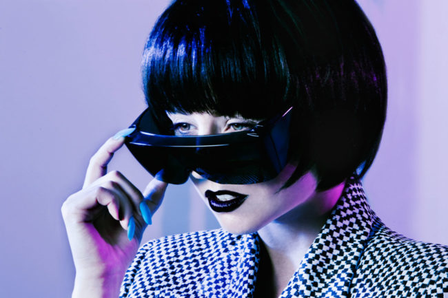 colored gel beauty image of girl taking off sunglasses