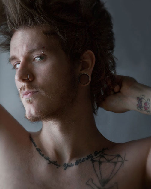 Portrait of Male with tattoos and piercings