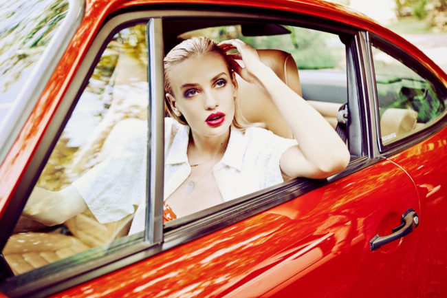Girl driving red porsche