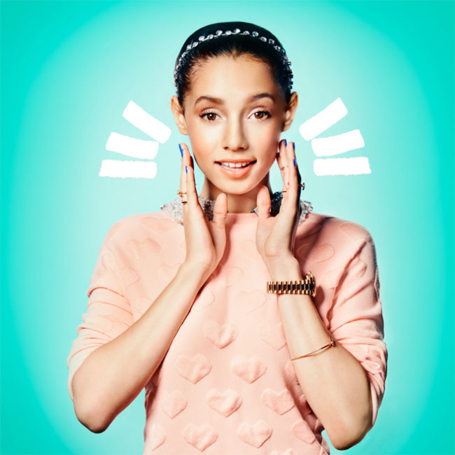 Excited girl with hands to face