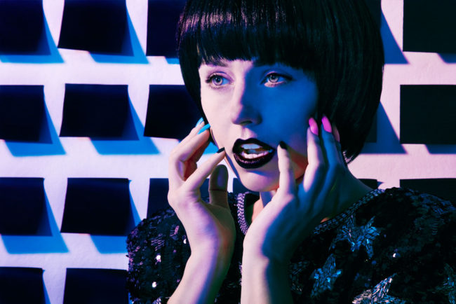 Colored Gel Beauty Image in front of wall of black post-it notes
